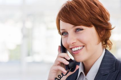 Closeup of a happy young businesswoman talking on phone
